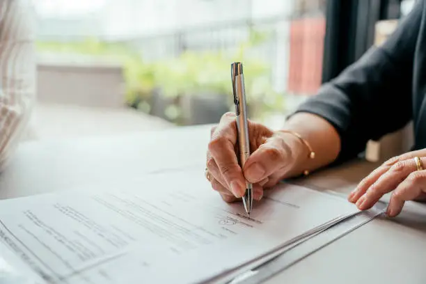 Signing a document at a table during a notary appointment